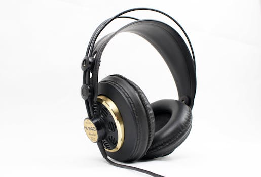 High-quality black and gold studio headphones with thick padding on a white background, ideal for music professionals.